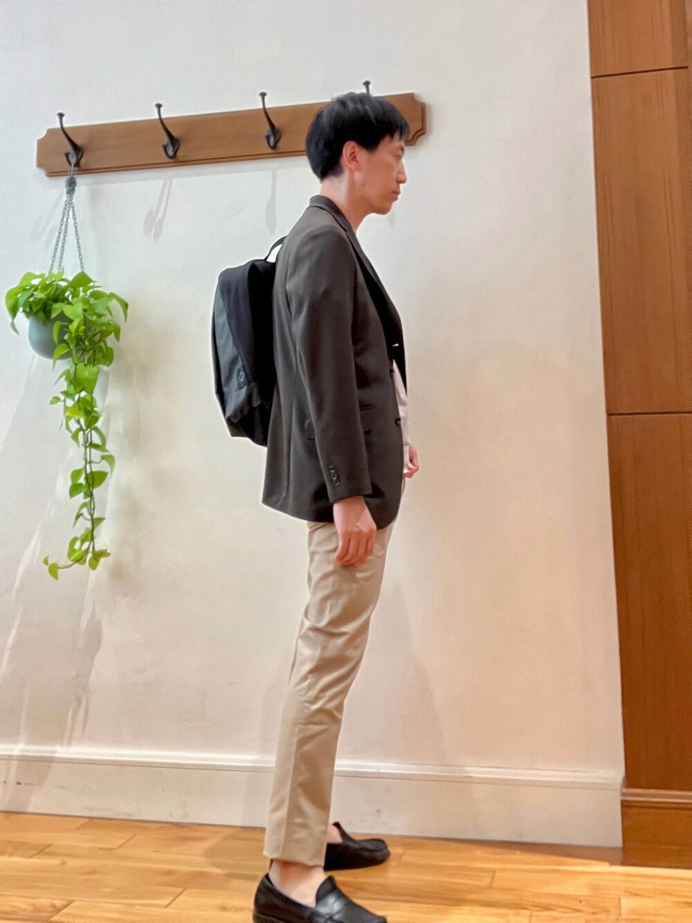 ブラウン系のテーラードジャケット、ベージュ系のTシャツ/カットソー、ブラック系のバックパック/リュックを着用したメンズの春コーディネートの4枚目の写真