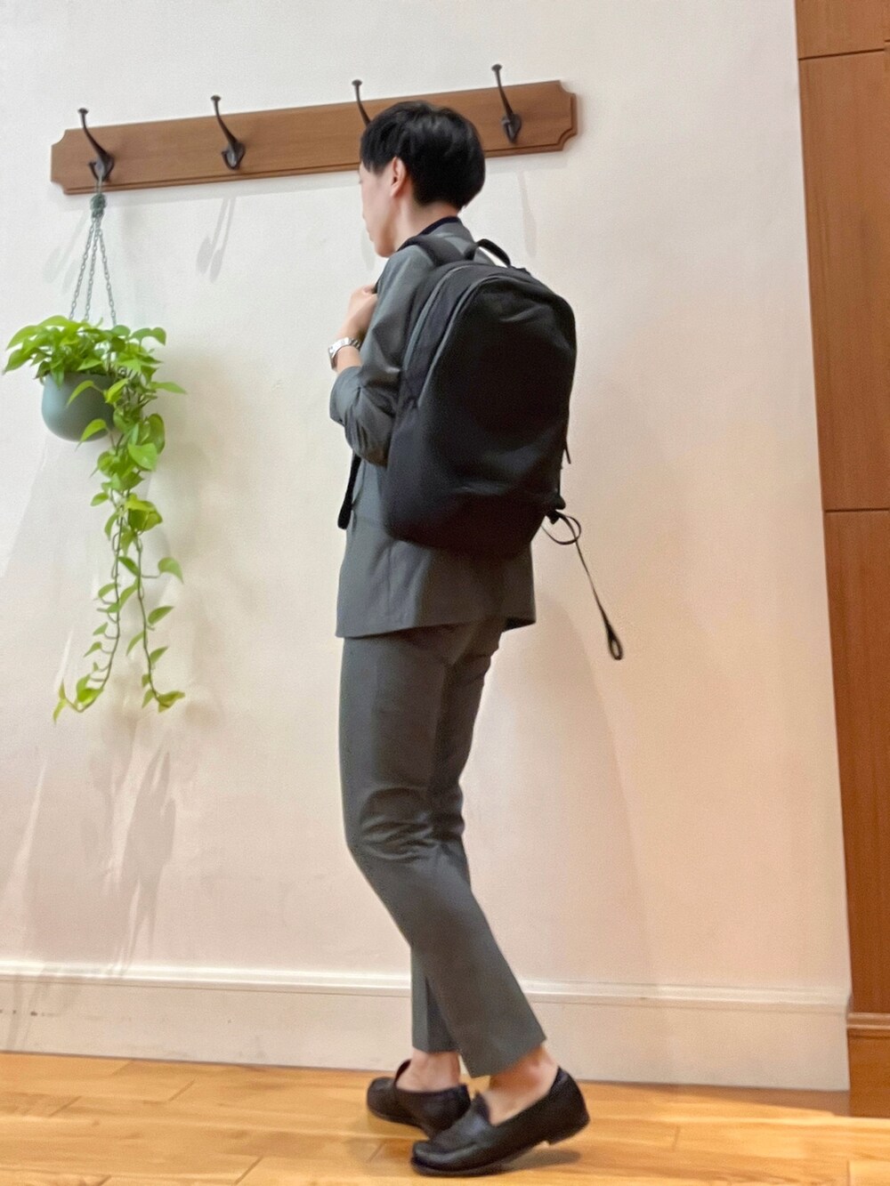 グレー系のテーラードジャケット、ブルー系のポロシャツ、ブラック系のバックパック/リュックを着用したメンズの春コーディネートの4枚目の写真