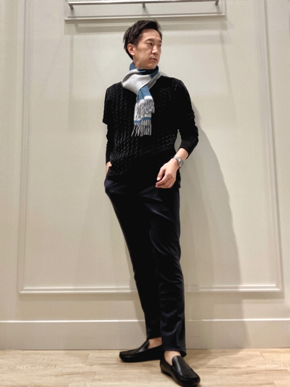 ブラック系のニット/セーター、ブルー系のその他パンツ、ブルー系のマフラーを着用したメンズの冬コーディネートの2枚目の写真