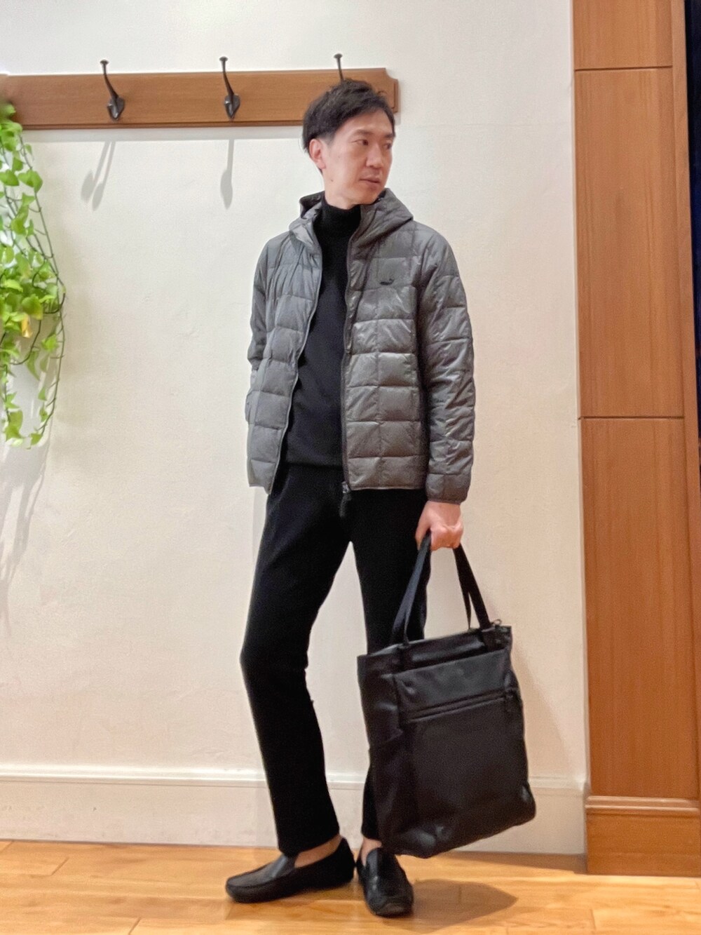 ブラック系のニット/セーター、グレー系のダウンジャケット/コート、ブラック系のその他パンツを着用したメンズの冬コーディネートの3枚目の写真