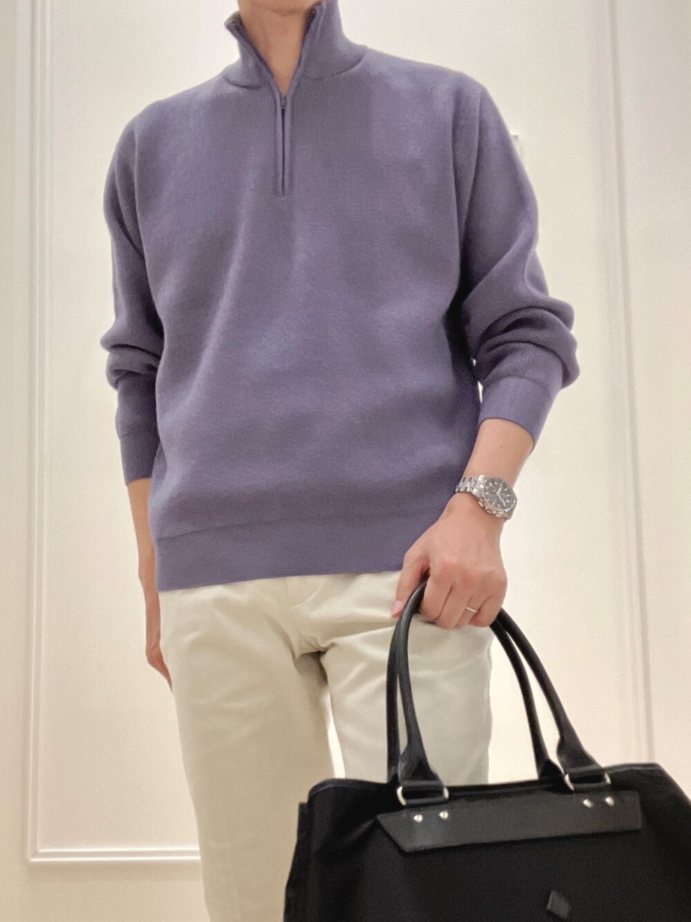 ブルー系のニット/セーター、ブラック系のトートバッグ、ホワイト系のチノパンツを着用したメンズの冬コーディネートの8枚目の写真