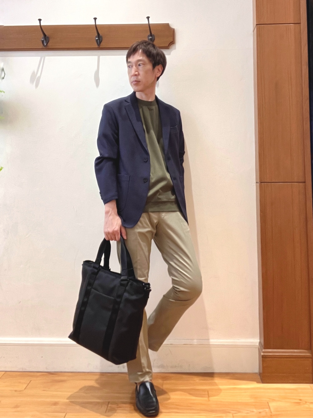 ブルー系のテーラードジャケット、グリーン系のTシャツ/カットソー、ベージュ系のチノパンツを着用したメンズの夏コーディネートの6枚目の写真