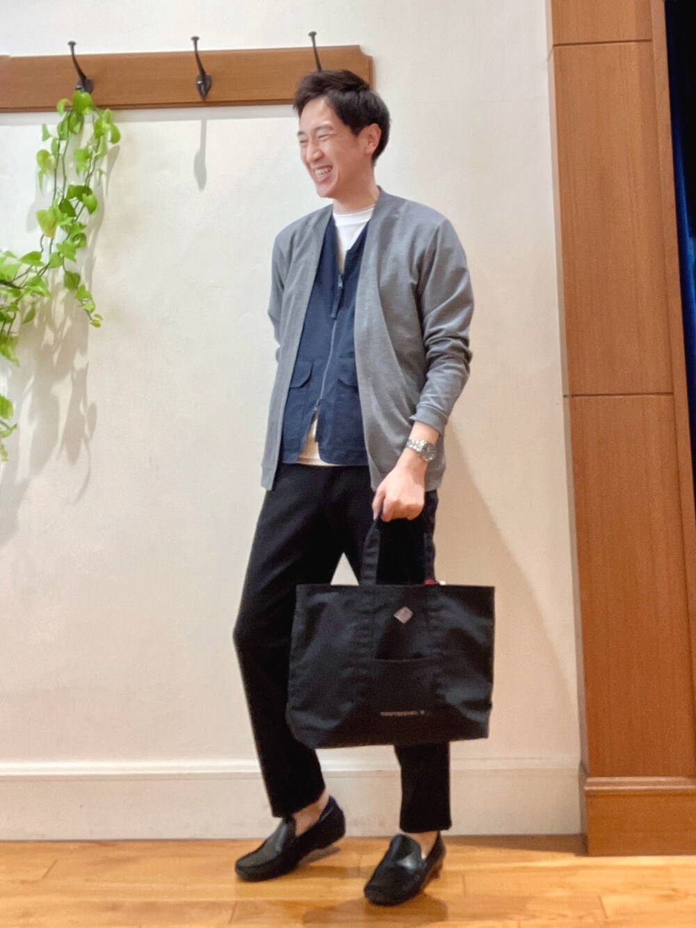 ブラック系のトートバッグ、ブラック系のその他パンツ、ホワイト系のTシャツ/カットソーを着用したメンズの春コーディネートの3枚目の写真