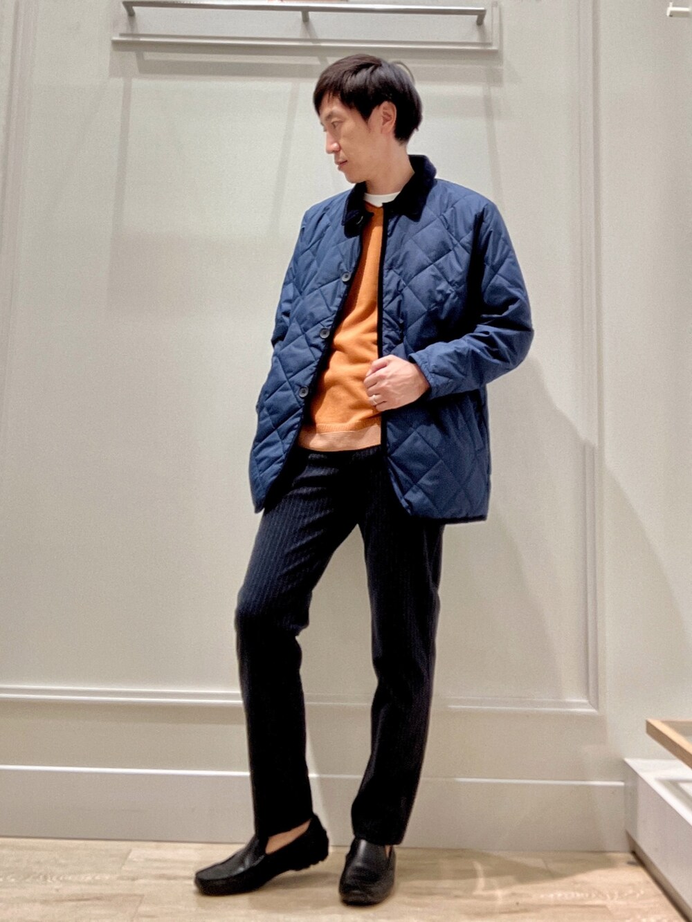 ブルー系のその他パンツ、イエロー系のニット/セーター、ブルー系のダウンジャケット/コートを着用したメンズの秋コーディネートの7枚目の写真