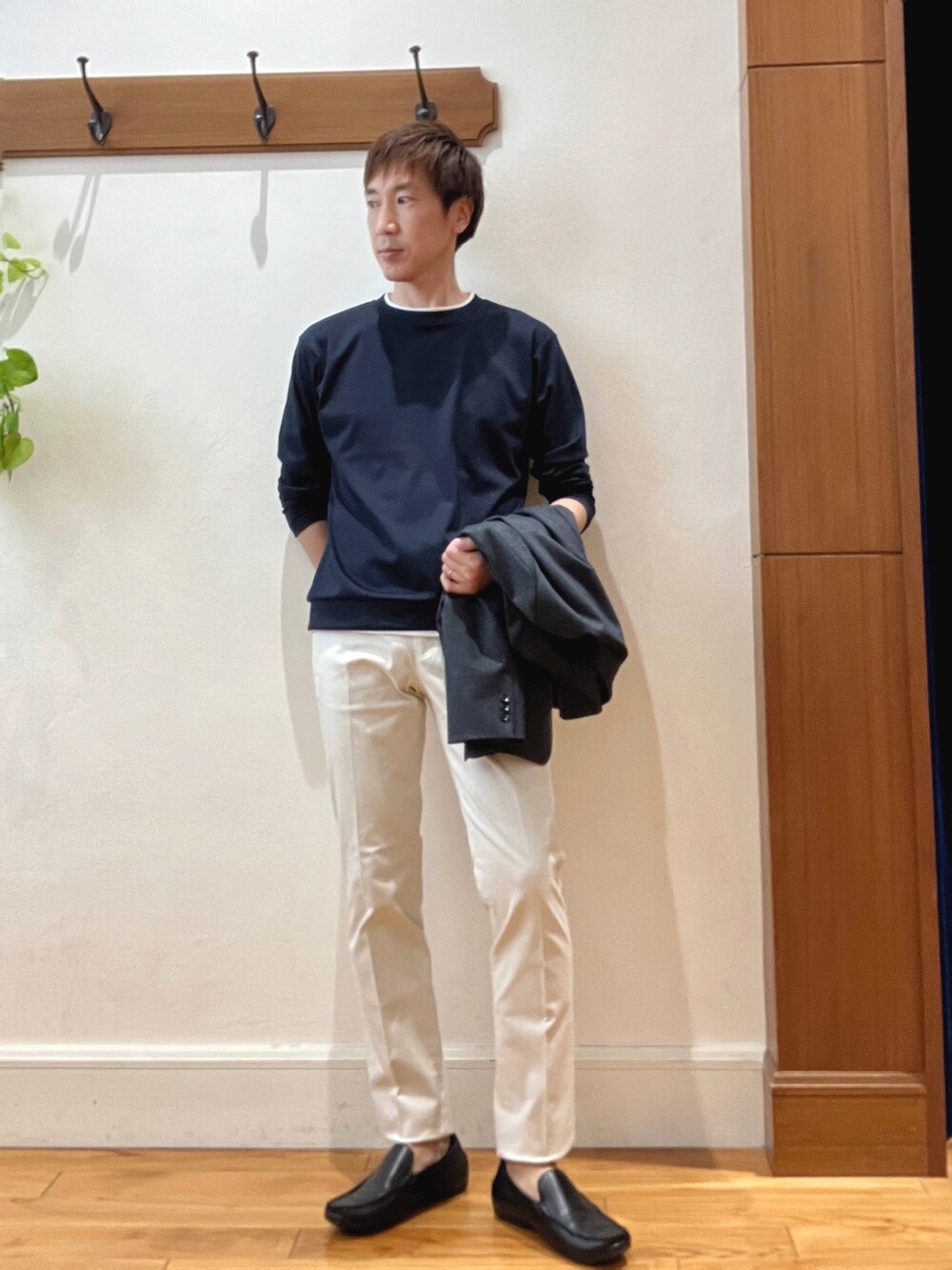 ホワイト系のチノパンツ、ブラック系のバックパック/リュック、ブルー系のテーラードジャケットを着用したメンズの秋コーディネートの8枚目の写真