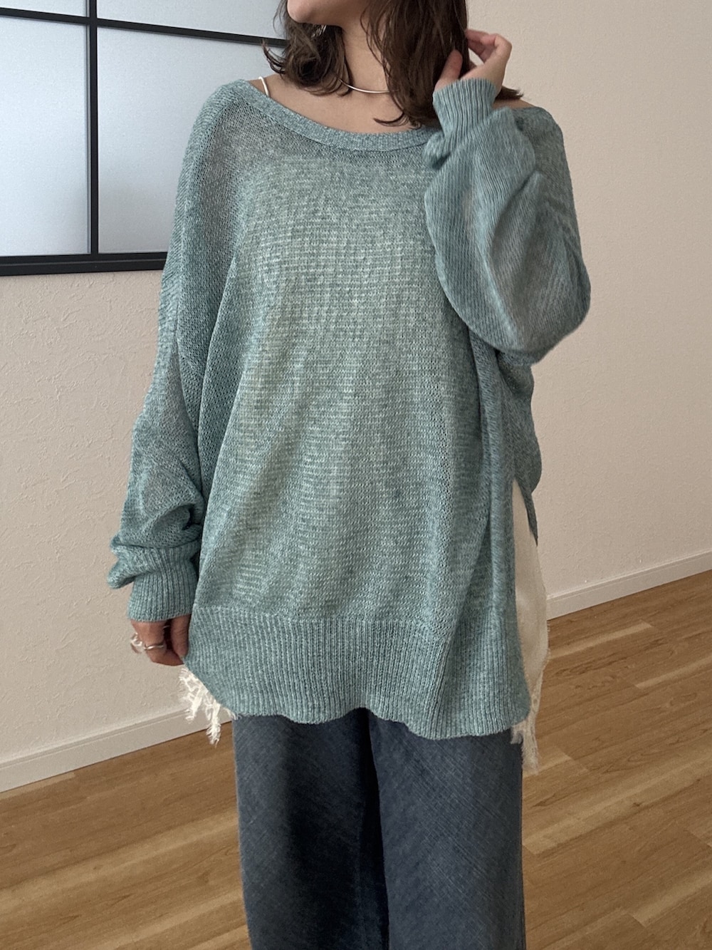 グリーン系のカーディガン/ボレロ、ブルー系のデニムパンツを着用したレディースの春コーディネートの5枚目の写真