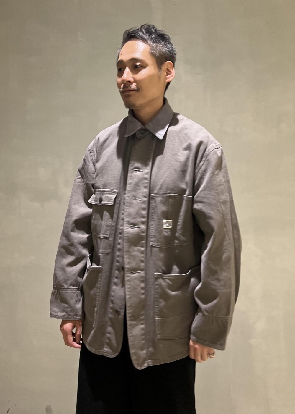 グレー系のスニーカー、グレー系のカバーオール、ブラック系のその他パンツを着用したメンズの夏コーディネートの4枚目の写真