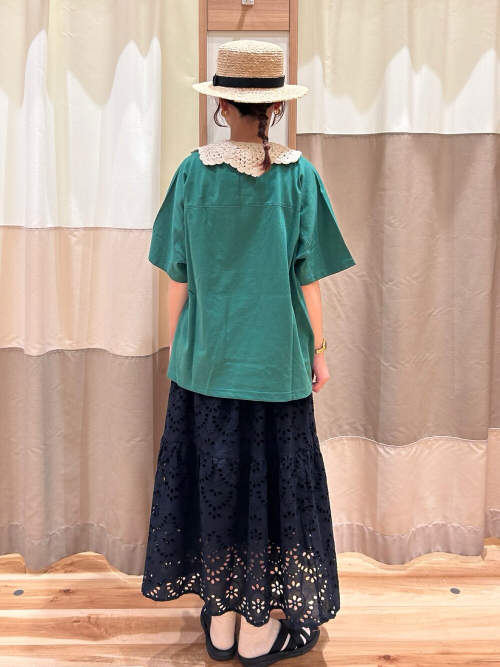 グリーン系のTシャツ/カットソー、ブラック系のサンダル、ブラック系のスカートを着用したレディースの春コーディネートの3枚目の写真