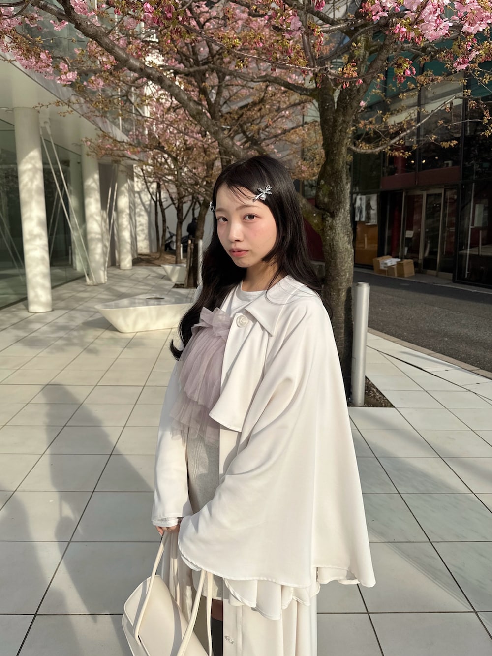 ホワイト系のトレンチコート、パープル系のトップス、ピンク系のその他を着用したレディースの春コーディネートの5枚目の写真