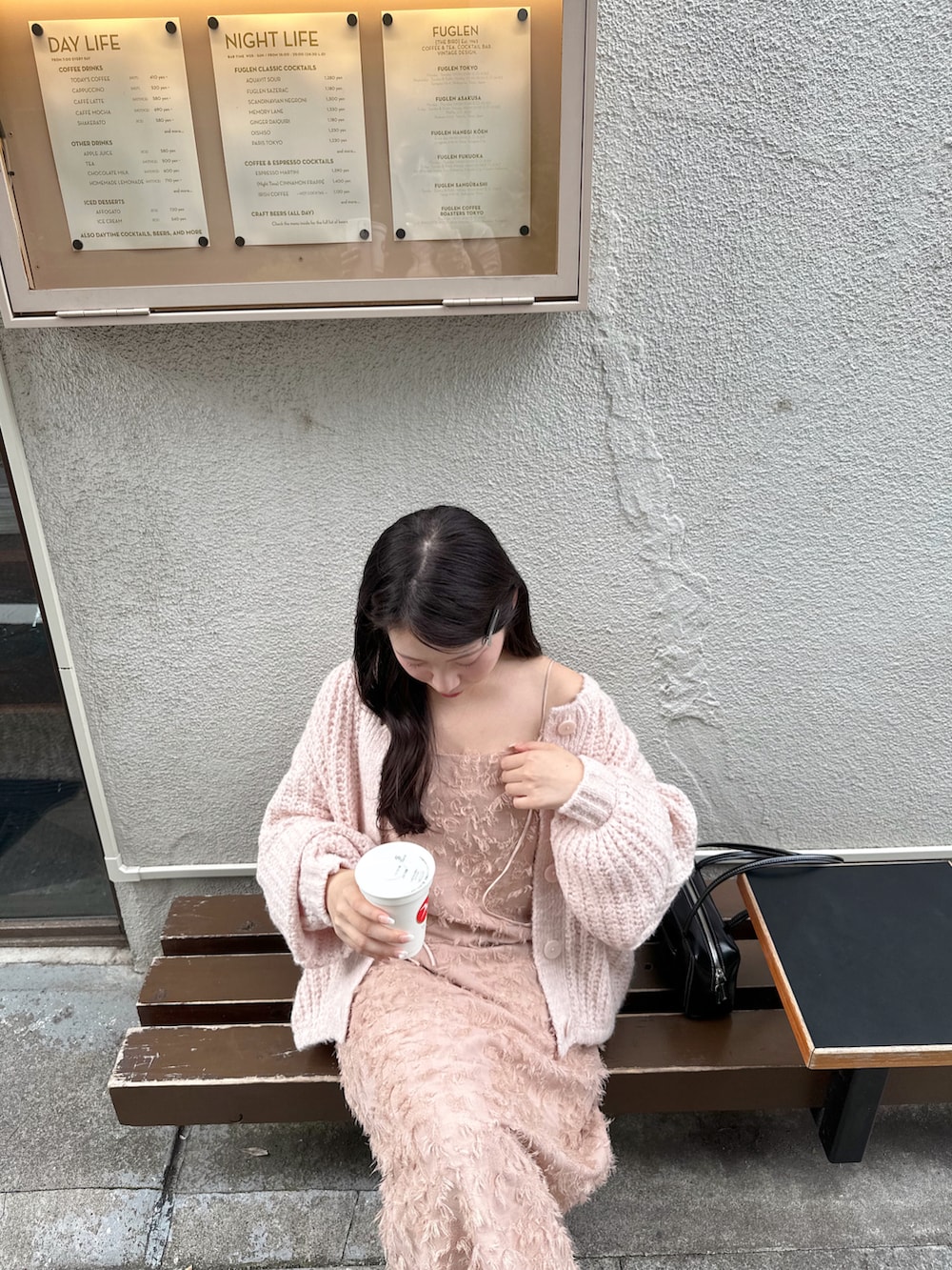 ピンク系のワンピース、ピンク系のカーディガン/ボレロ、ブラック系のショルダーバッグを着用したレディースの秋コーディネートの3枚目の写真