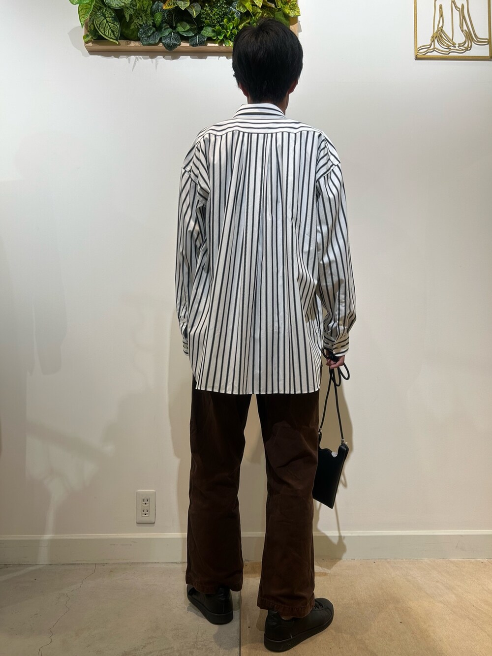 ブラック系のTシャツ/カットソー、ホワイト系のシャツ/ブラウス、ブラック系のショルダーバッグを着用したメンズの秋コーディネートの3枚目の写真