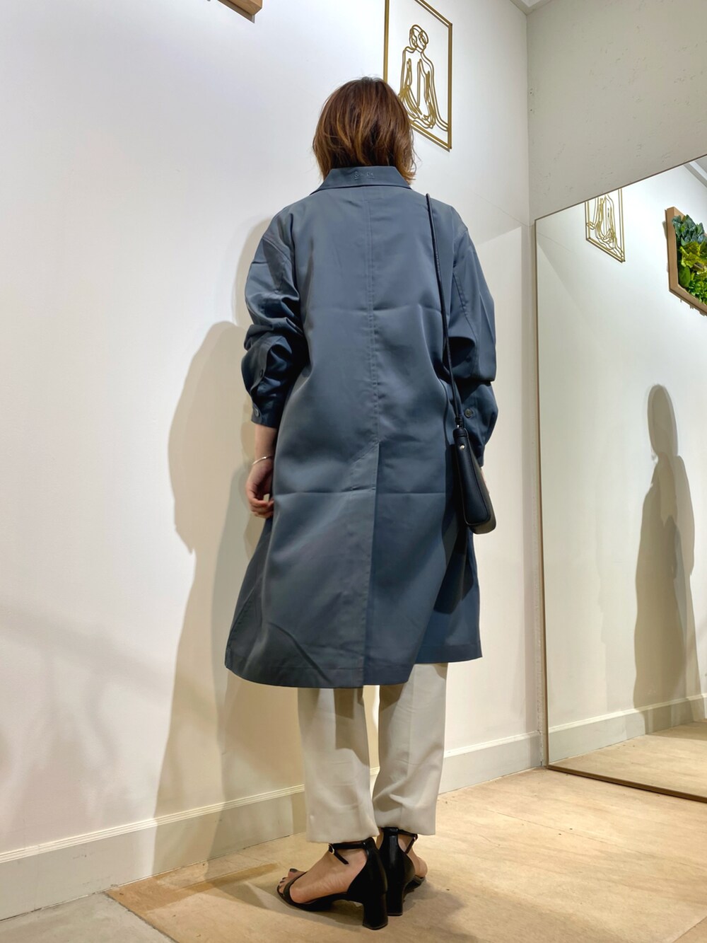 ホワイト系のパンツ、ピンク系のTシャツ/カットソー、ブラック系のショルダーバッグを着用したレディースの秋コーディネートの4枚目の写真