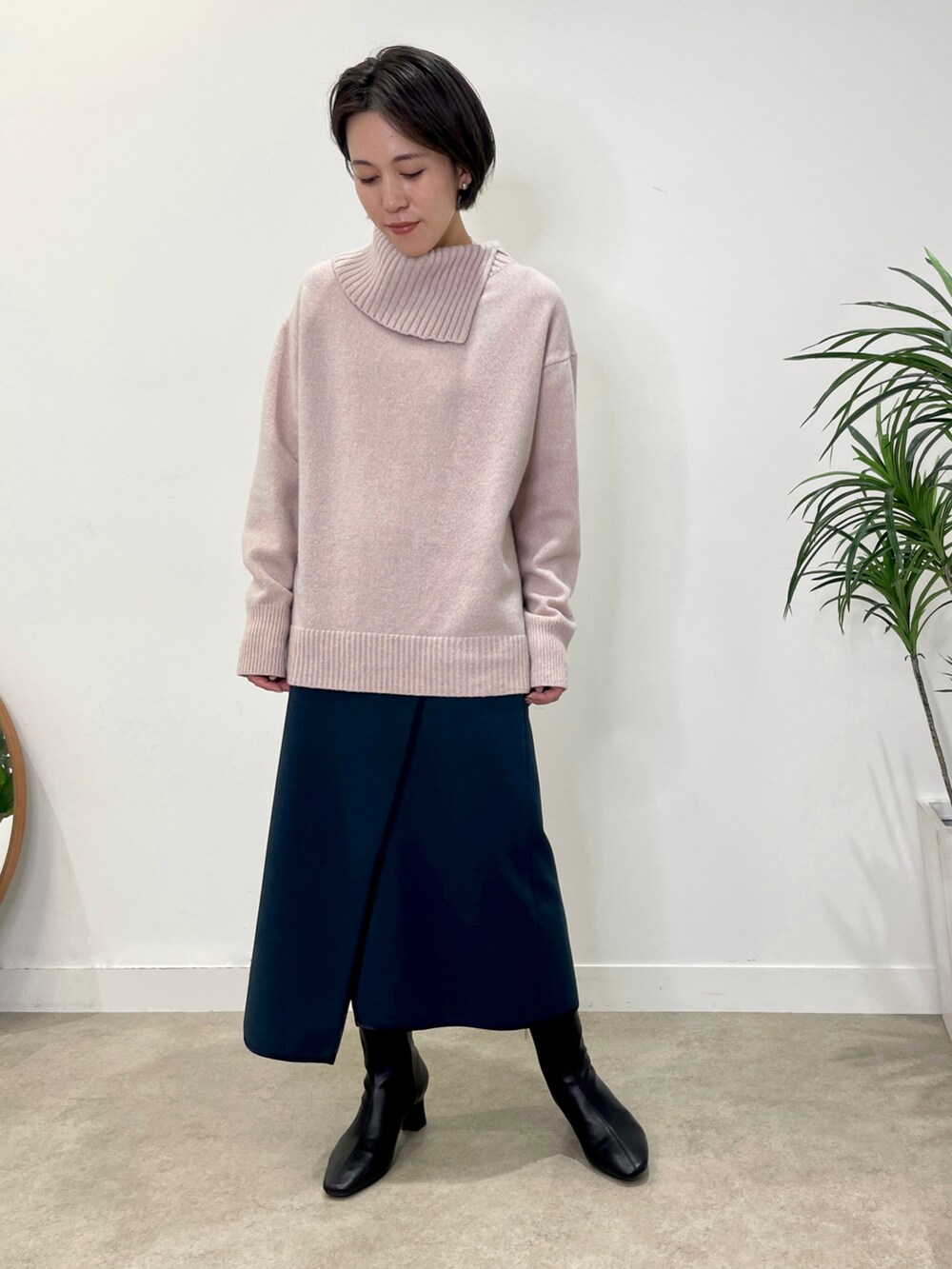 ブラック系のブーツ、パープル系のニット/セーター、ホワイト系のトートバッグを着用したレディースの冬コーディネートの3枚目の写真