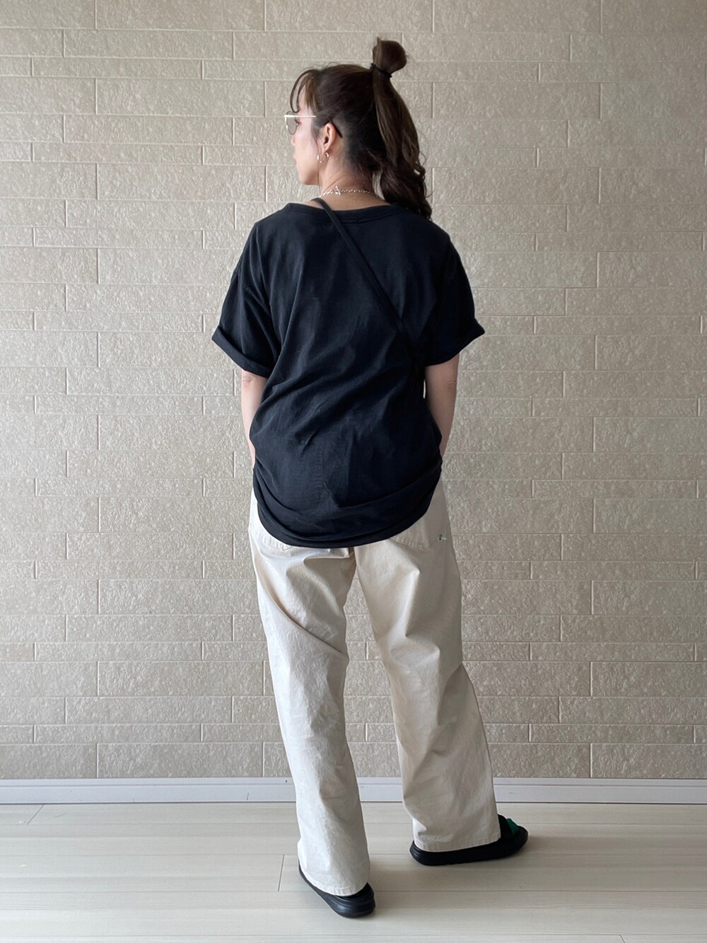 ホワイト系のその他パンツ、ブラック系のサンダル、グレー系のTシャツ/カットソーを着用したレディースの春コーディネートの5枚目の写真