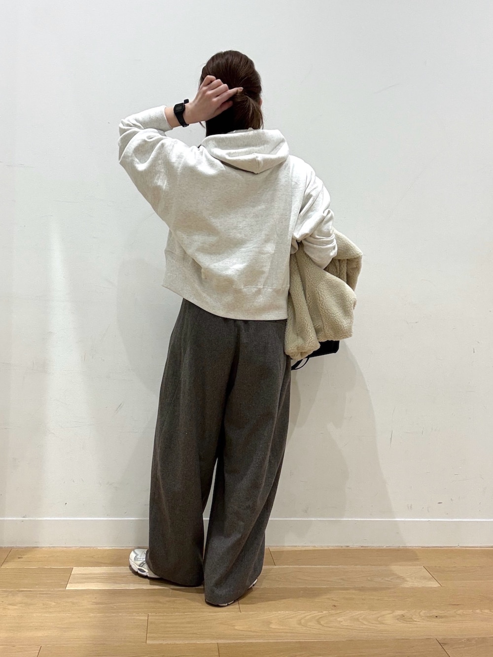 ベージュ系のパーカー、ホワイト系のその他アウター、ブラック系のショルダーバッグを着用したレディースの冬コーディネートの6枚目の写真