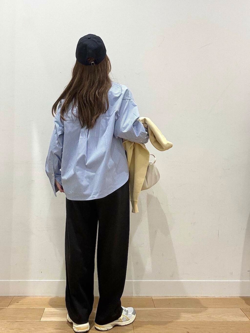 ホワイト系のTシャツ/カットソー、ホワイト系のショルダーバッグ、グレー系のその他パンツを着用したレディースの冬コーディネートの5枚目の写真