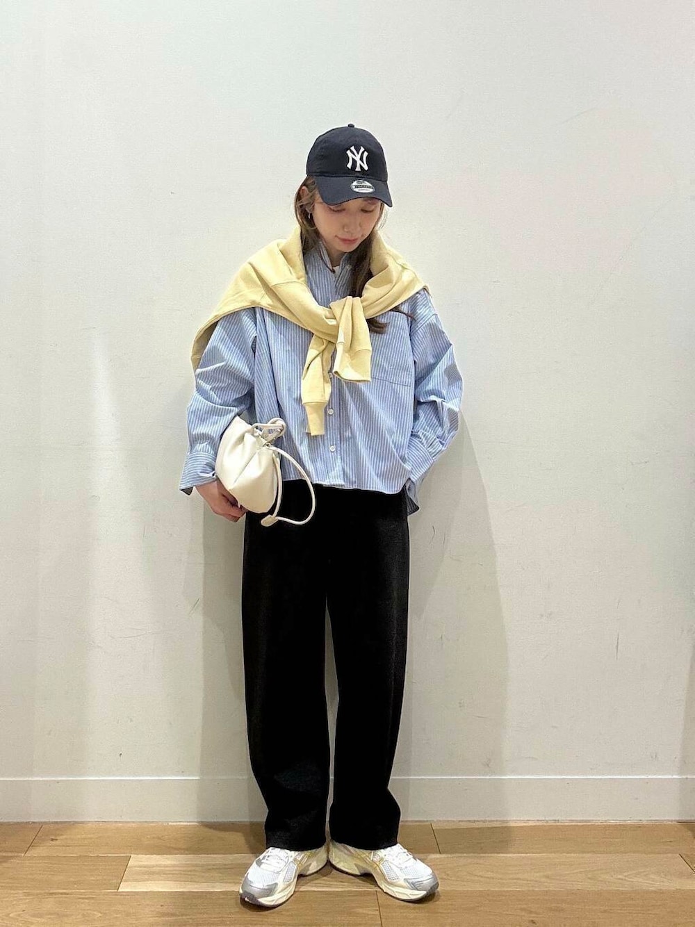 ホワイト系のTシャツ/カットソー、ホワイト系のショルダーバッグ、グレー系のその他パンツを着用したレディースの冬コーディネートの2枚目の写真