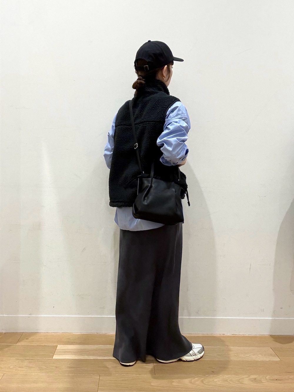 グレー系のベスト、ブラック系のダウンジャケット/コート、ブルー系のシャツ/ブラウスを着用したレディースの冬コーディネートの3枚目の写真