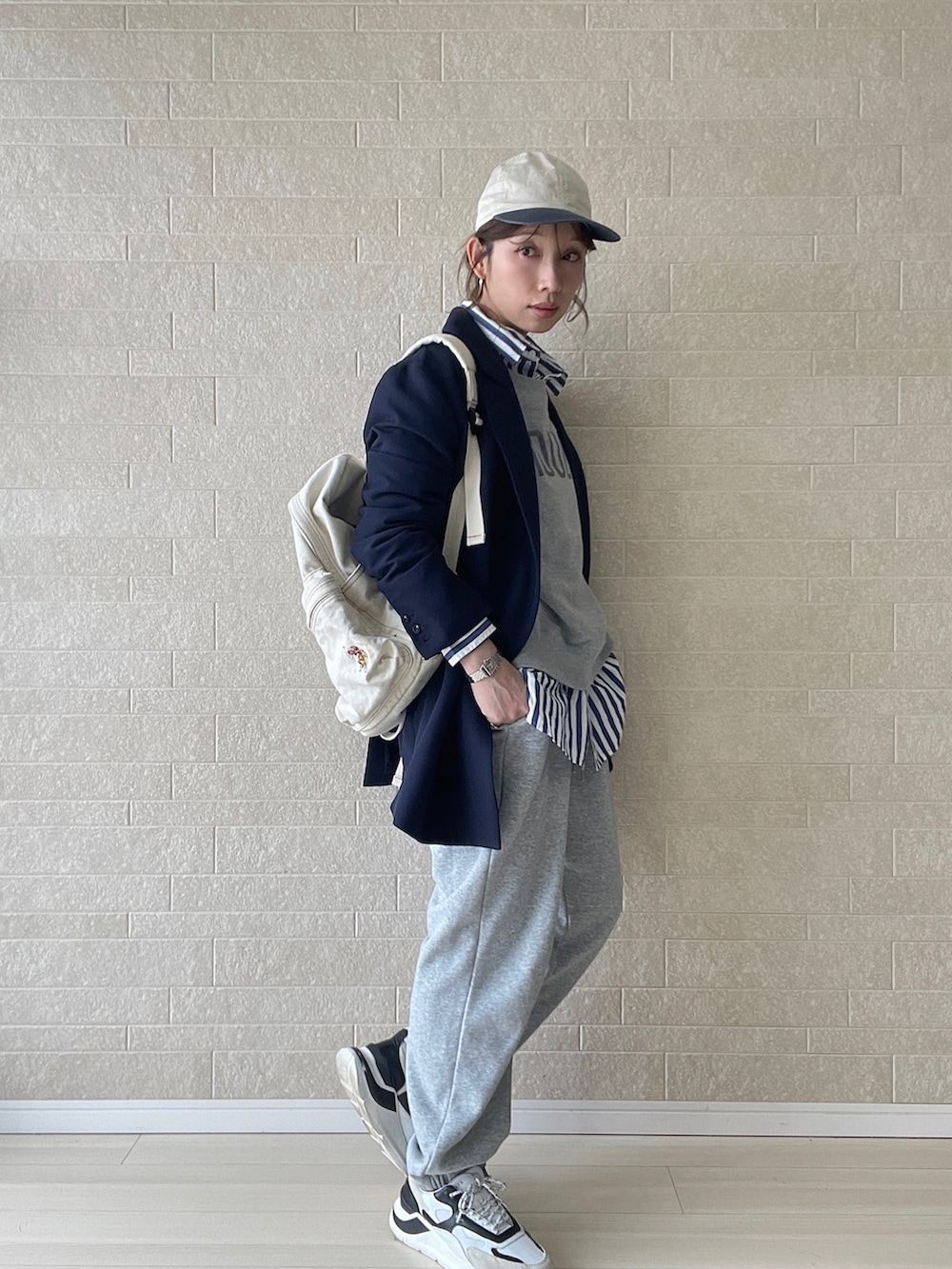 ホワイト系のバックパック/リュック、ブルー系のシャツ/ブラウス、グレー系のスウェットパンツを着用したレディースの冬コーディネートの3枚目の写真