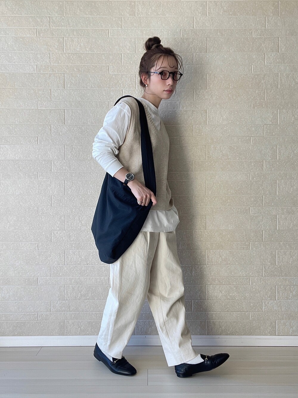 ホワイト系のその他パンツ、ブラック系のショルダーバッグ、ベージュ系のベストを着用したレディースの冬コーディネートの4枚目の写真