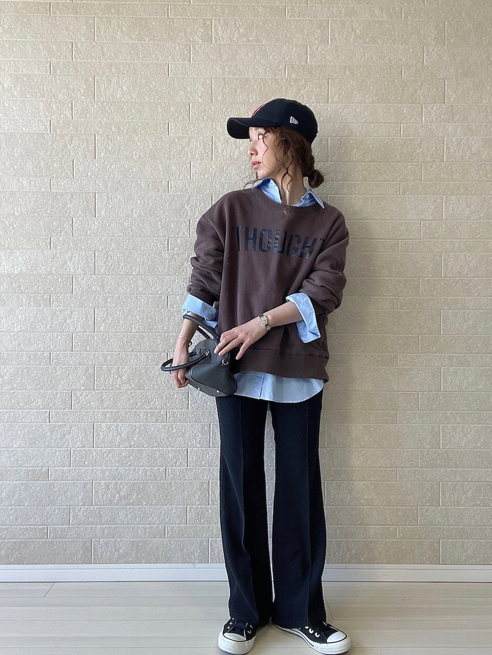 ブラック系のその他パンツ、グレー系のボストンバッグ、ブラウン系のスウェットを着用したレディースの秋コーディネートの2枚目の写真