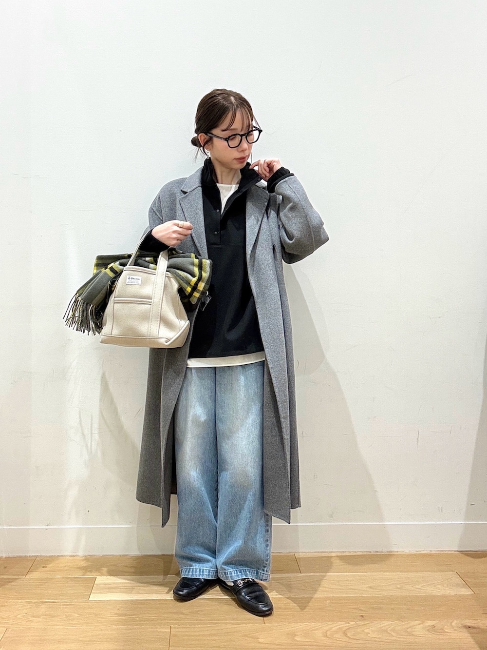 ホワイト系のシャツ/ブラウス、ブルー系のデニムパンツ、ベージュ系のトートバッグを着用したレディースの冬コーディネートの2枚目の写真