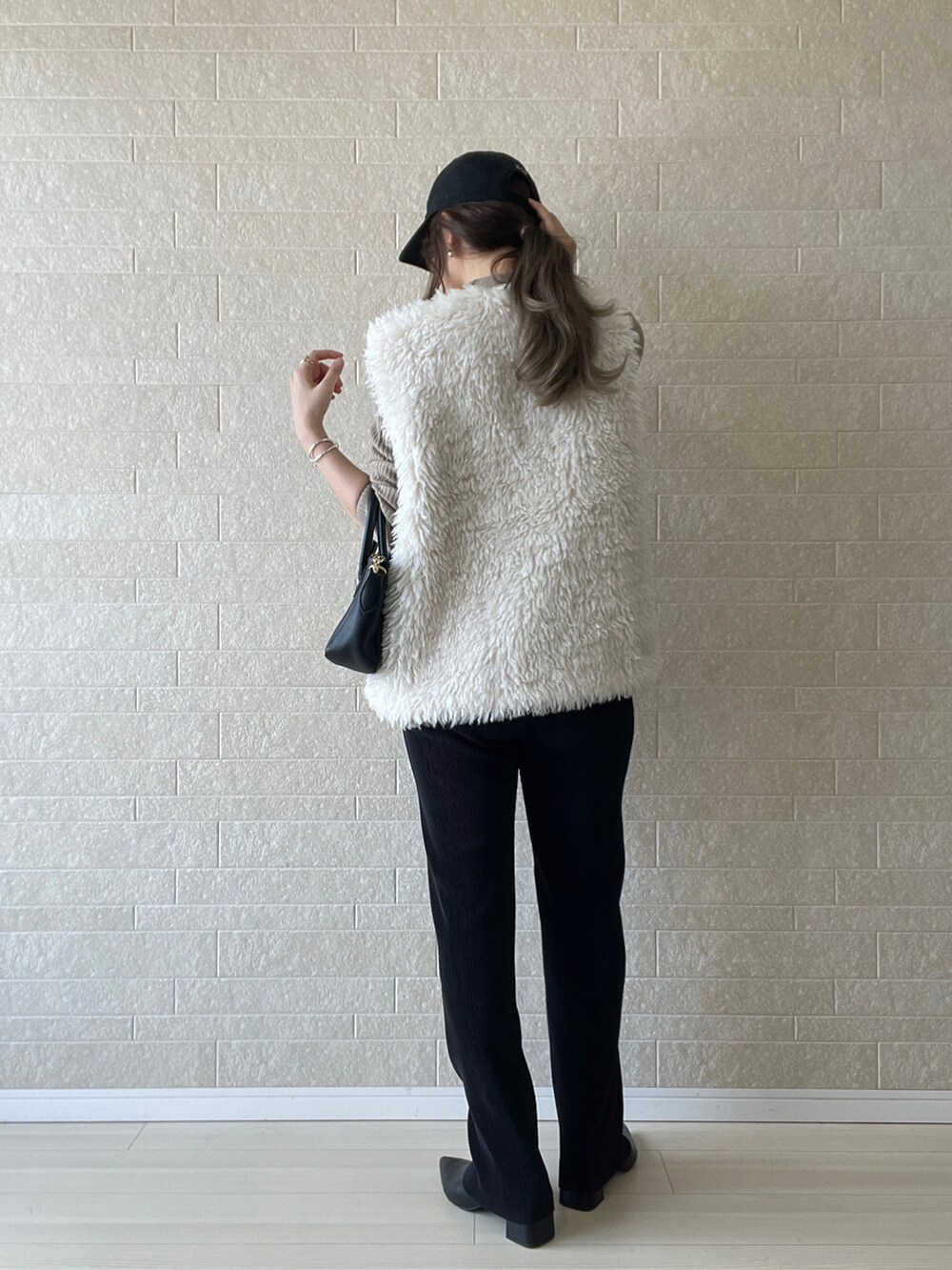 ブラック系のブーツ、ベージュ系のニット/セーター、ブラック系のその他パンツを着用したレディースの秋コーディネートの4枚目の写真