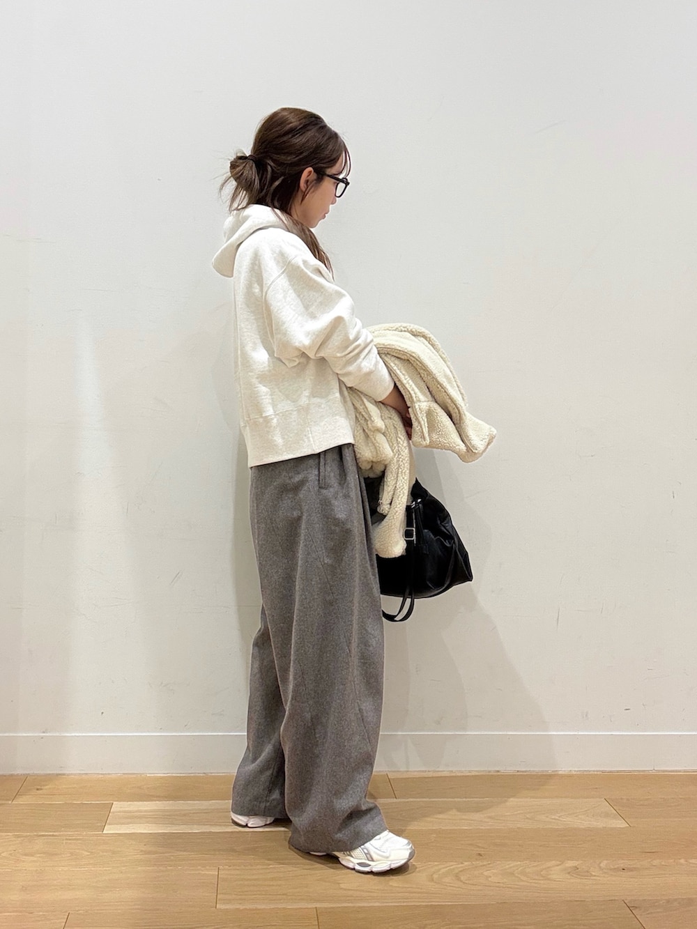 ベージュ系のパーカー、ホワイト系のその他アウター、ブラック系のショルダーバッグを着用したレディースの冬コーディネートの5枚目の写真