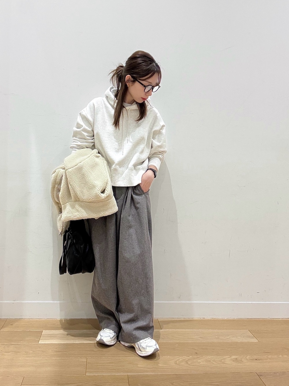 ベージュ系のパーカー、ホワイト系のその他アウター、ブラック系のショルダーバッグを着用したレディースの冬コーディネートの7枚目の写真