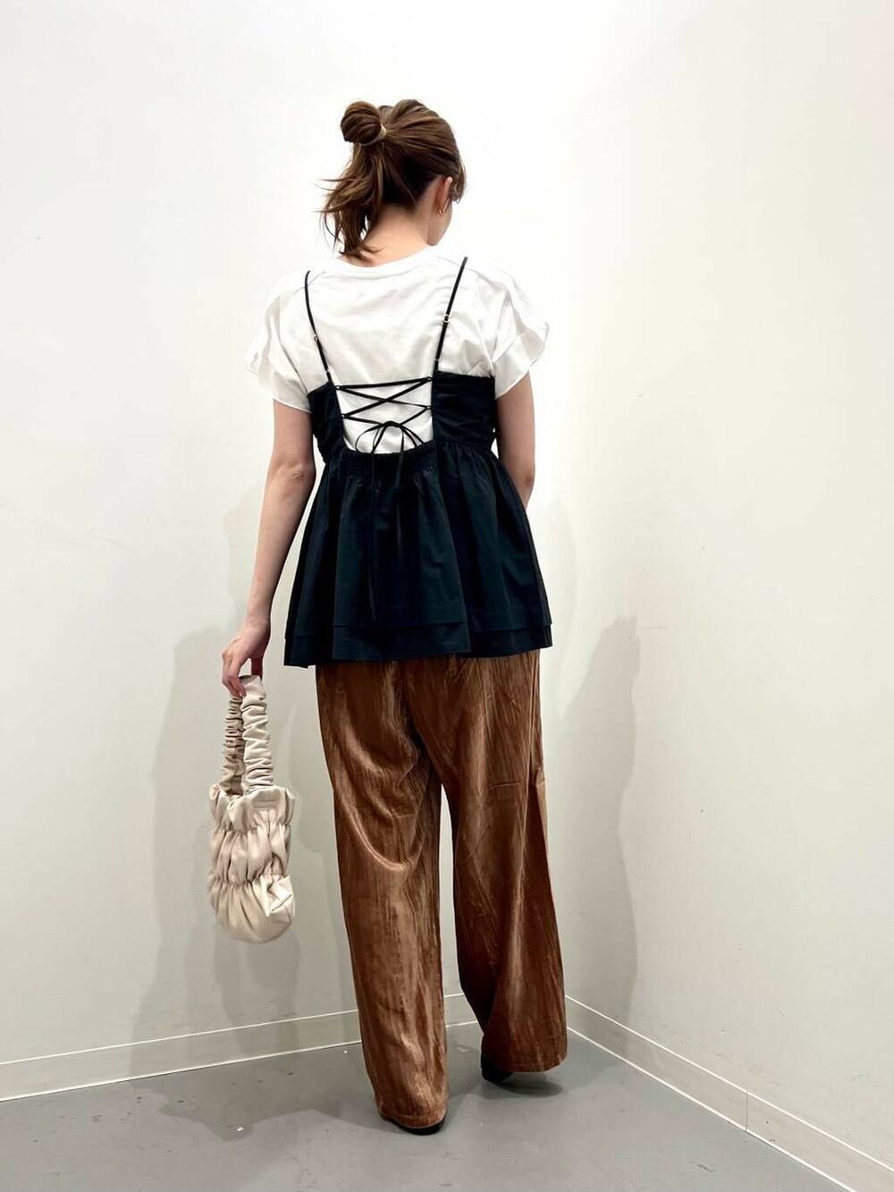 ブラック系のローファー、ホワイト系のハンドバッグ、ブラック系のキャミソールを着用したレディースの夏コーディネートの3枚目の写真