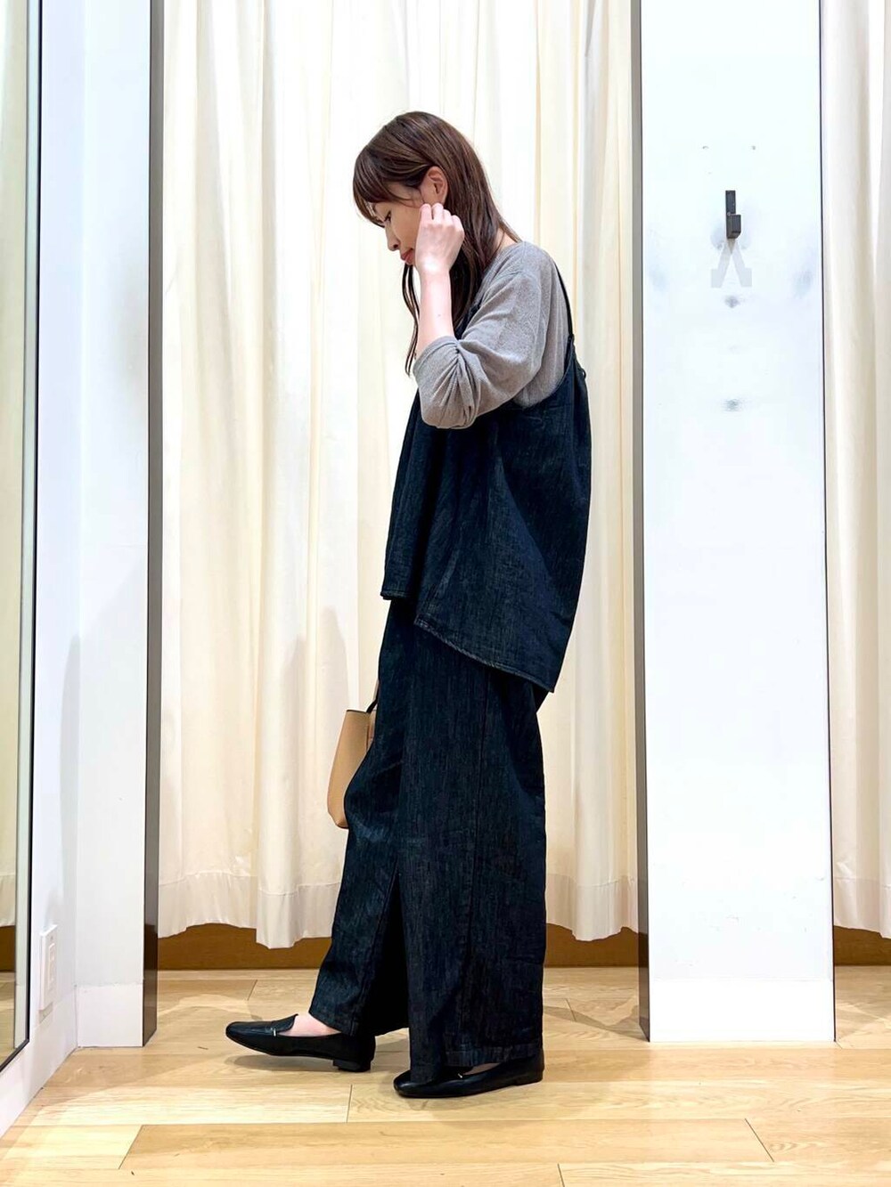 ブラック系のローファー、ベージュ系のトートバッグ、ブラック系のサロペット/オーバーオールを着用したレディースの秋コーディネートの2枚目の写真