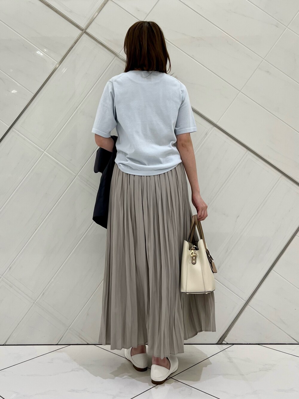 ブルー系のTシャツ/カットソー、グレー系のその他アウター、ベージュ系のスカートを着用したレディースの春コーディネートの6枚目の写真