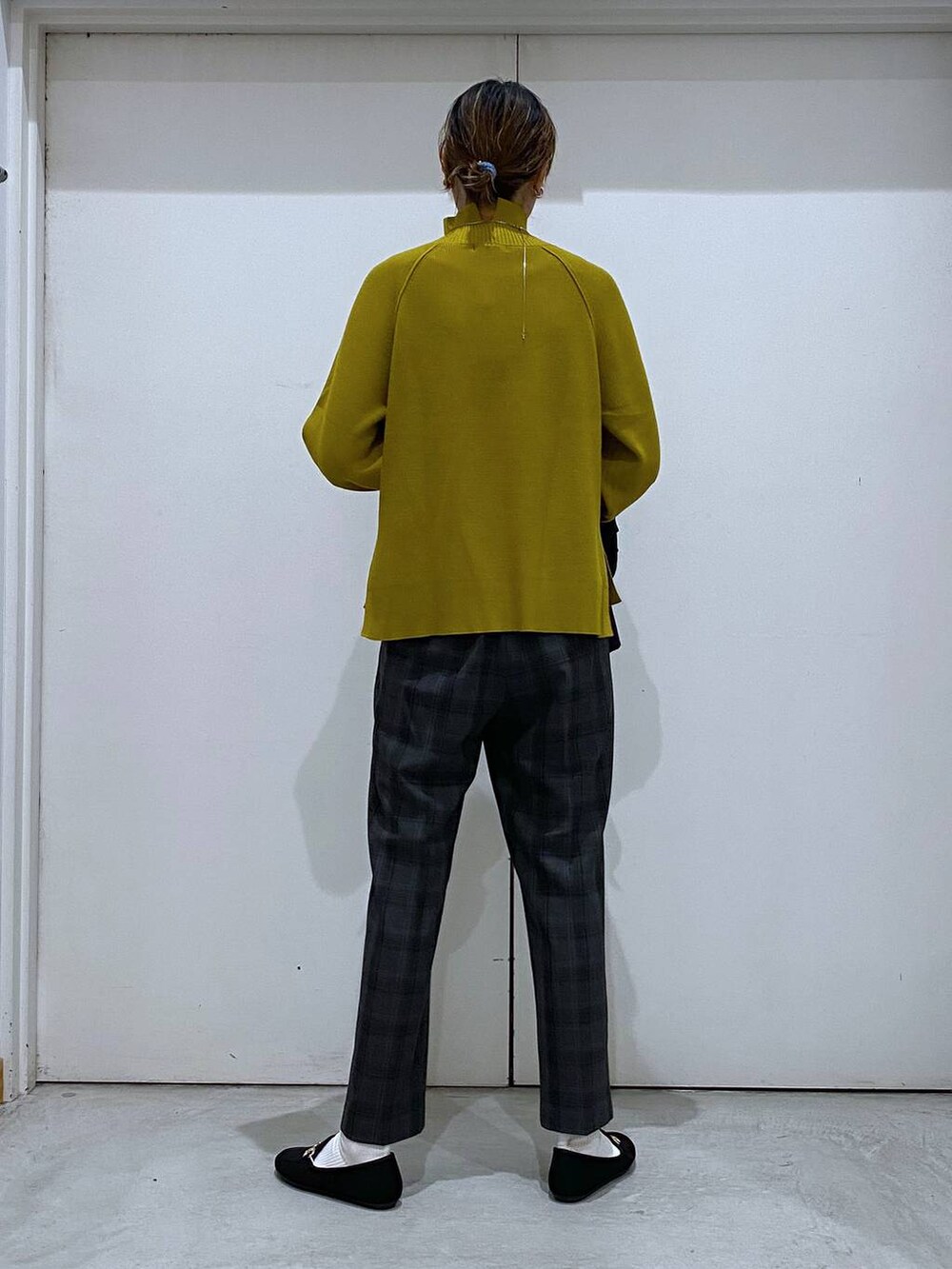 ブラック系のトートバッグ、イエロー系のニット/セーター、ブラック系のテーラードジャケットを着用したレディースの秋コーディネートの8枚目の写真