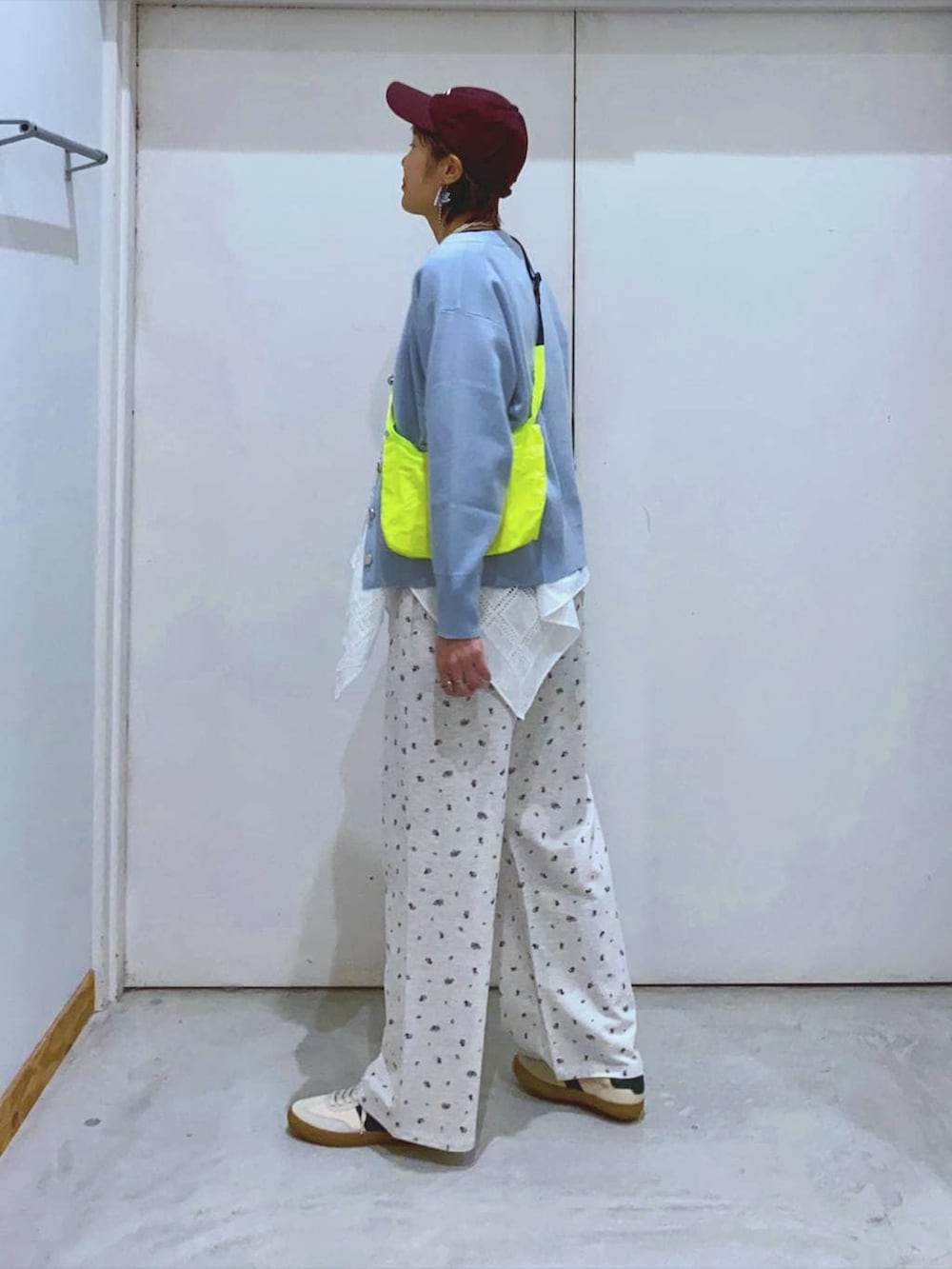 ベージュ系のスニーカー、イエロー系のショルダーバッグ、ブルー系のカーディガン/ボレロを着用したレディースの春コーディネートの3枚目の写真