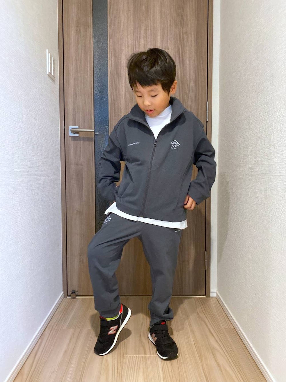 グレー系のブルゾン、ホワイト系のTシャツ/カットソー、グレー系のその他パンツを着用したキッズの秋コーディネートの5枚目の写真