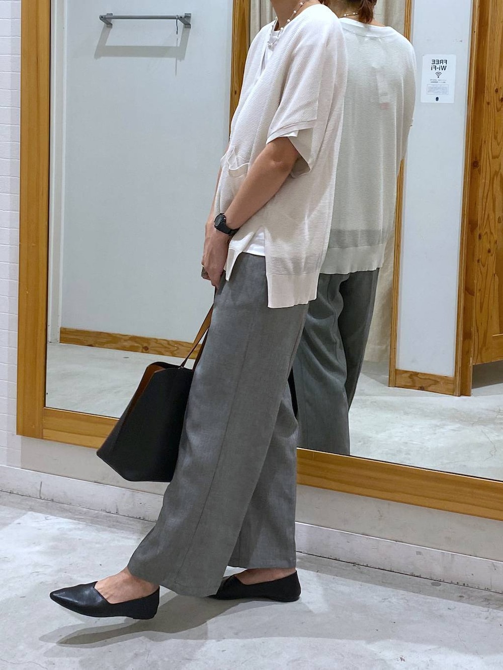 ブラック系のパンプス、ブラック系のトートバッグ、グレー系のその他パンツを着用したレディースの夏コーディネートの2枚目の写真