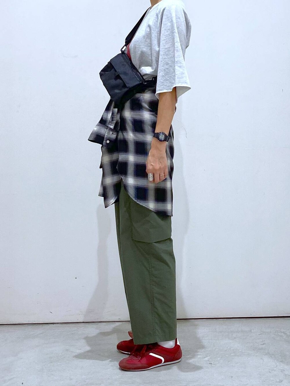 グリーン系のカーゴパンツ、ブラック系のシャツ/ブラウス、グレー系のTシャツ/カットソーを着用したレディースの秋コーディネートの2枚目の写真