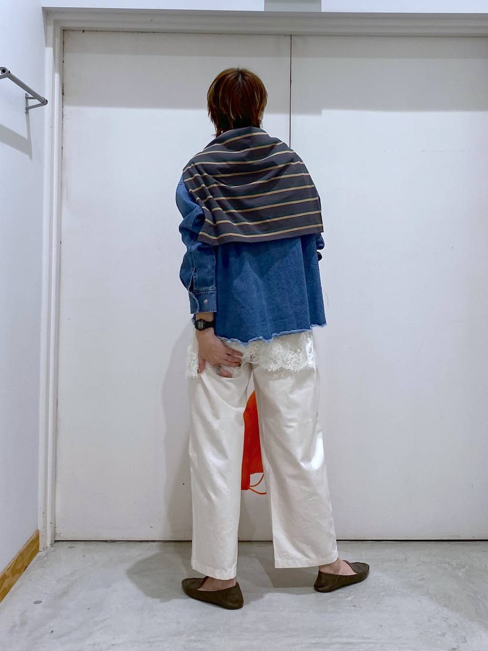 オレンジ系のバックパック/リュック、ブルー系のシャツ/ブラウス、グレー系のTシャツ/カットソーを着用したレディースの春コーディネートの3枚目の写真