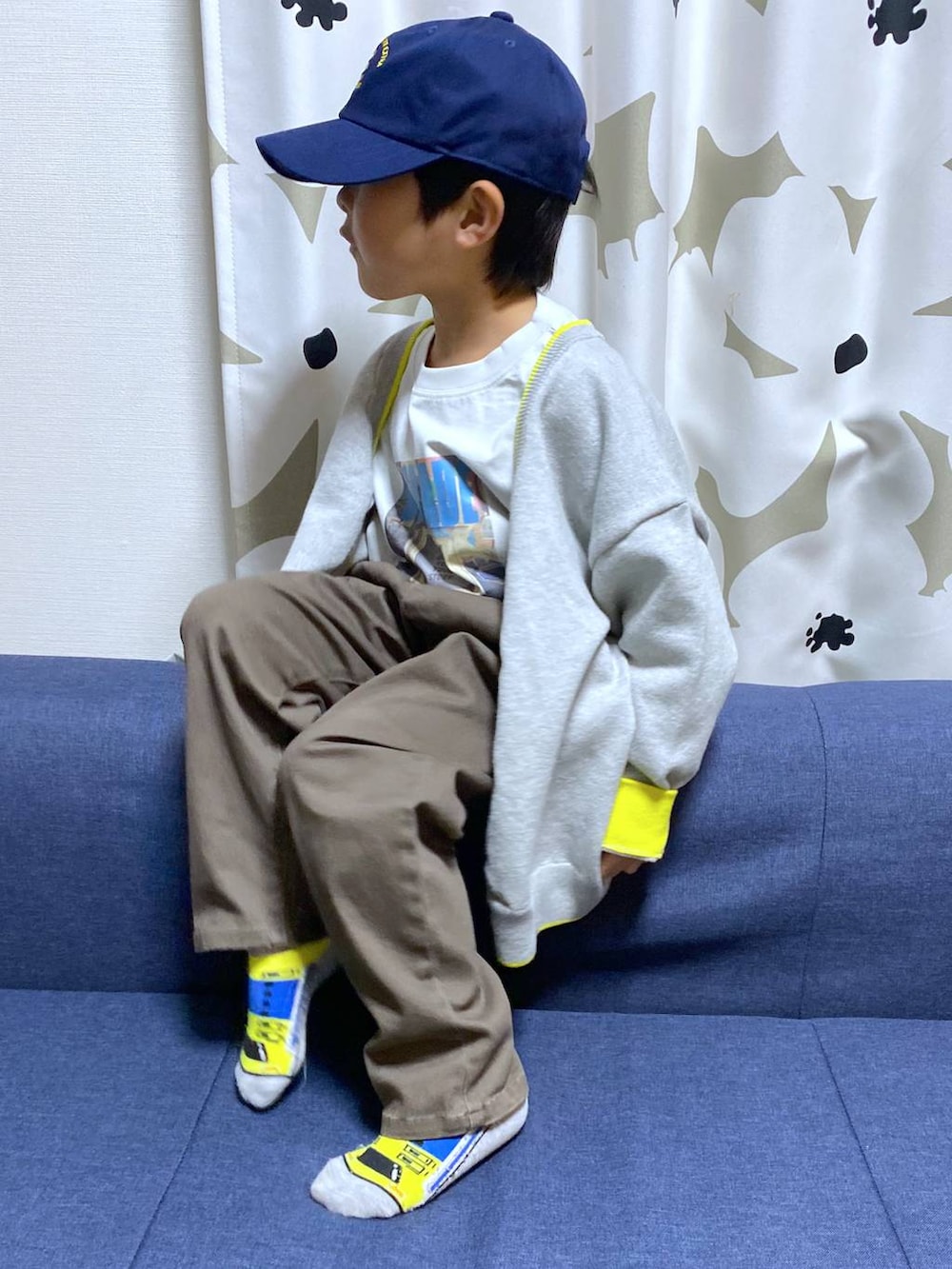 ブラウン系のデニムパンツ、グレー系のTシャツ/カットソー、グレー系のニット/セーターを着用したキッズの冬コーディネートの2枚目の写真