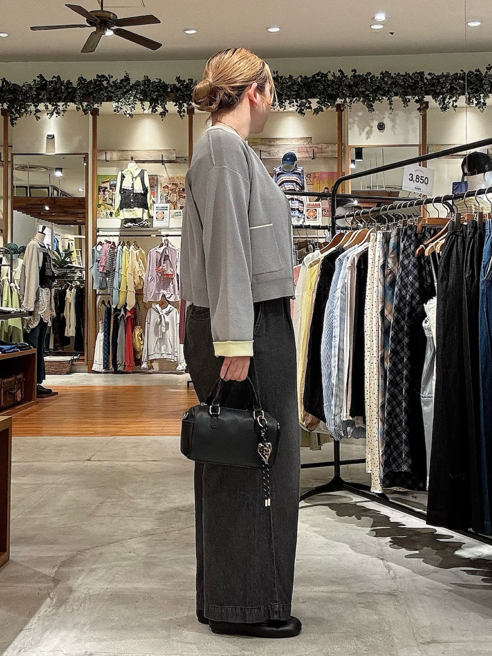 グレー系のカーディガン/ボレロ、ブラック系のショルダーバッグ、ブラック系のデニムパンツを着用したレディースの春コーディネートの2枚目の写真