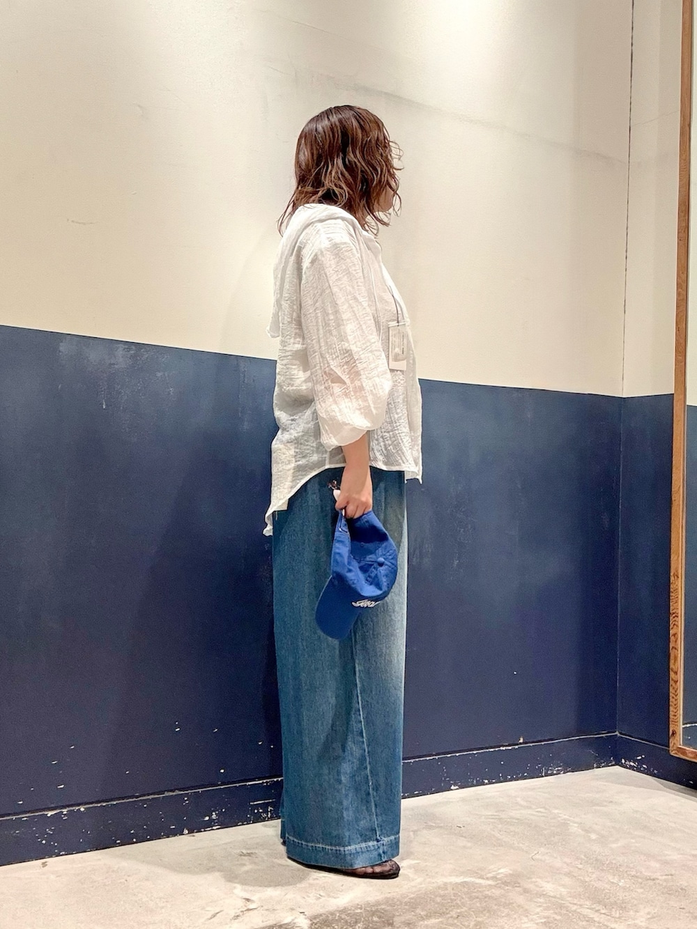 ホワイト系のシャツ/ブラウス、グレー系のTシャツ/カットソー、ブルー系のデニムパンツを着用したレディースの夏コーディネートの2枚目の写真