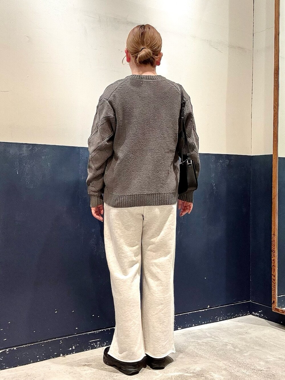 ホワイト系のスウェットパンツ、ブラック系のショルダーバッグ、ホワイト系のTシャツ/カットソーを着用したレディースの春コーディネートの3枚目の写真