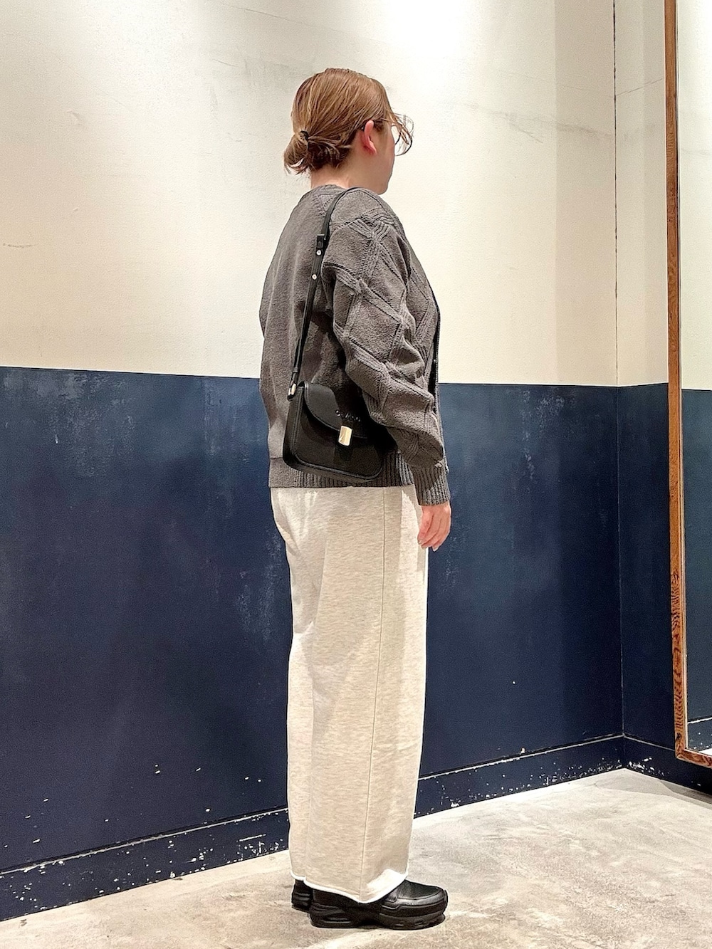 ホワイト系のスウェットパンツ、ブラック系のショルダーバッグ、ホワイト系のTシャツ/カットソーを着用したレディースの春コーディネートの2枚目の写真