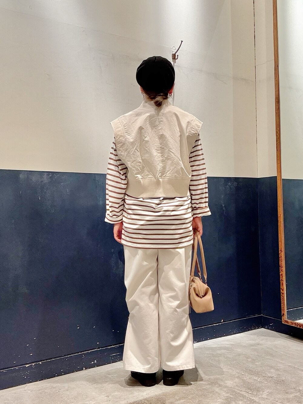 ホワイト系のベスト、ブラウン系のTシャツ/カットソー、ホワイト系のサロペット/オーバーオールを着用したレディースの春コーディネートの3枚目の写真