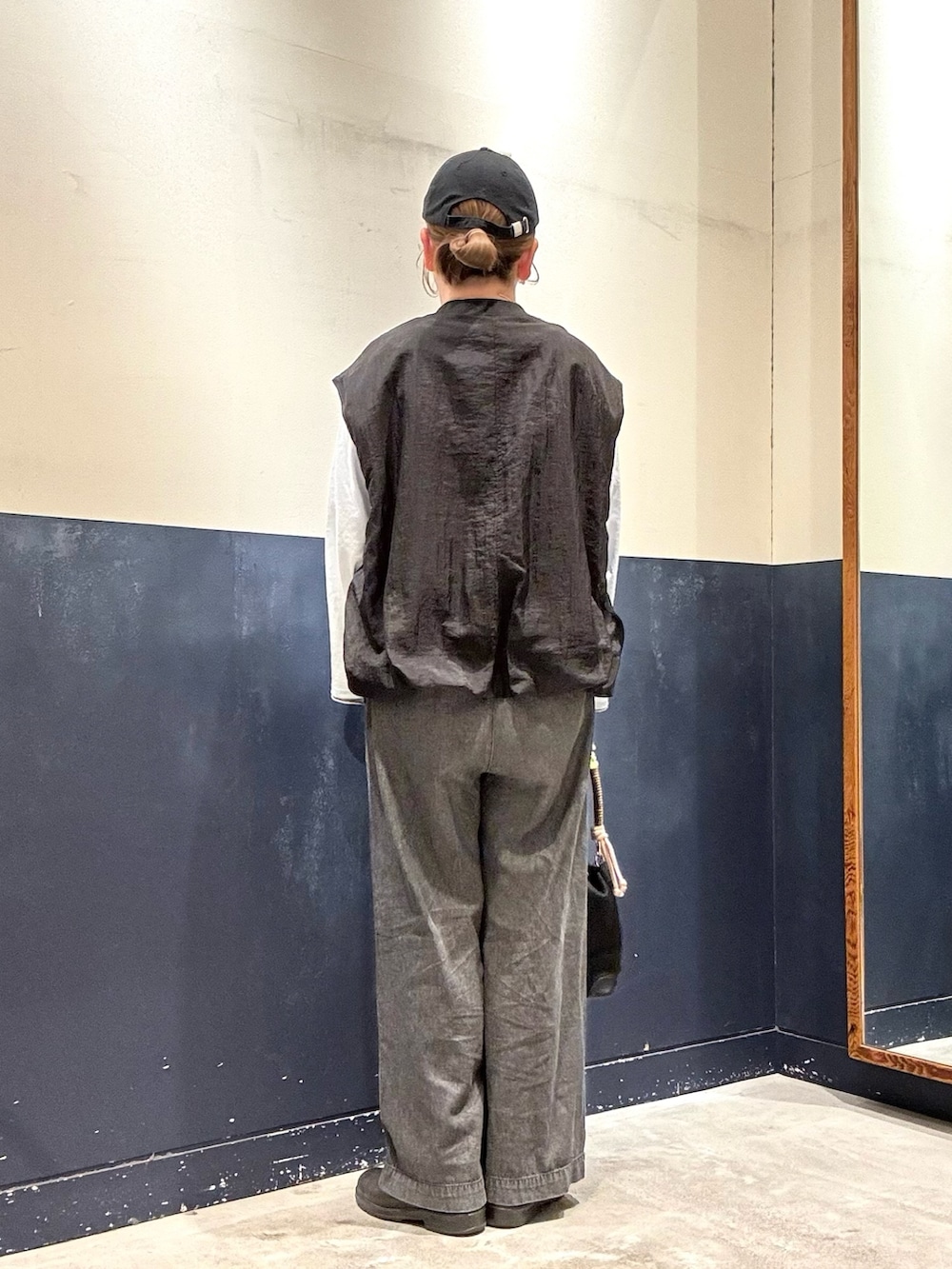 ブラック系のショルダーバッグ、ブルー系のTシャツ/カットソー、ブラック系のデニムパンツを着用したレディースの春コーディネートの3枚目の写真