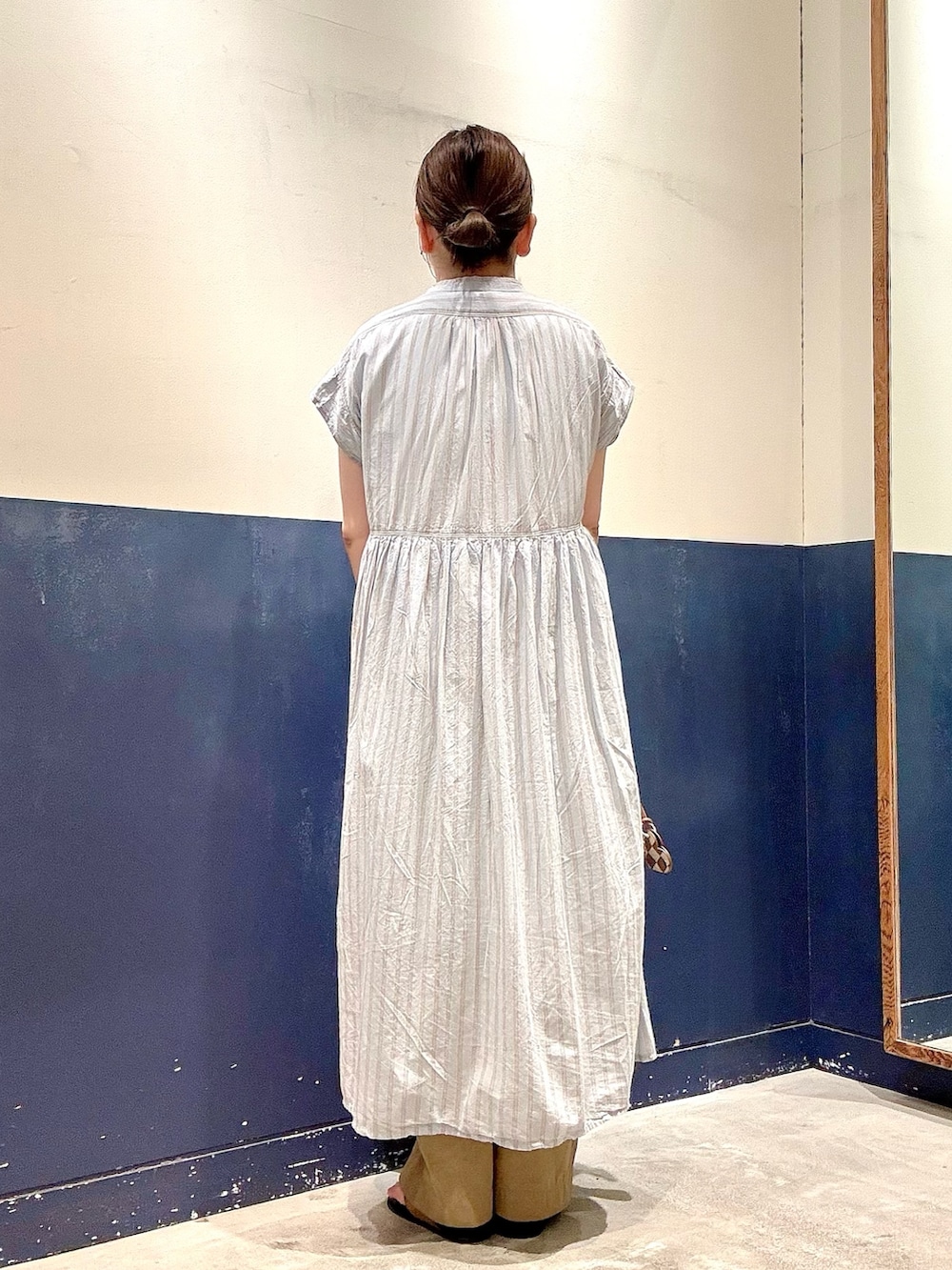 イエロー系のサンダル、ブルー系のワンピース、ホワイト系のTシャツ/カットソーを着用したレディースの夏コーディネートの3枚目の写真