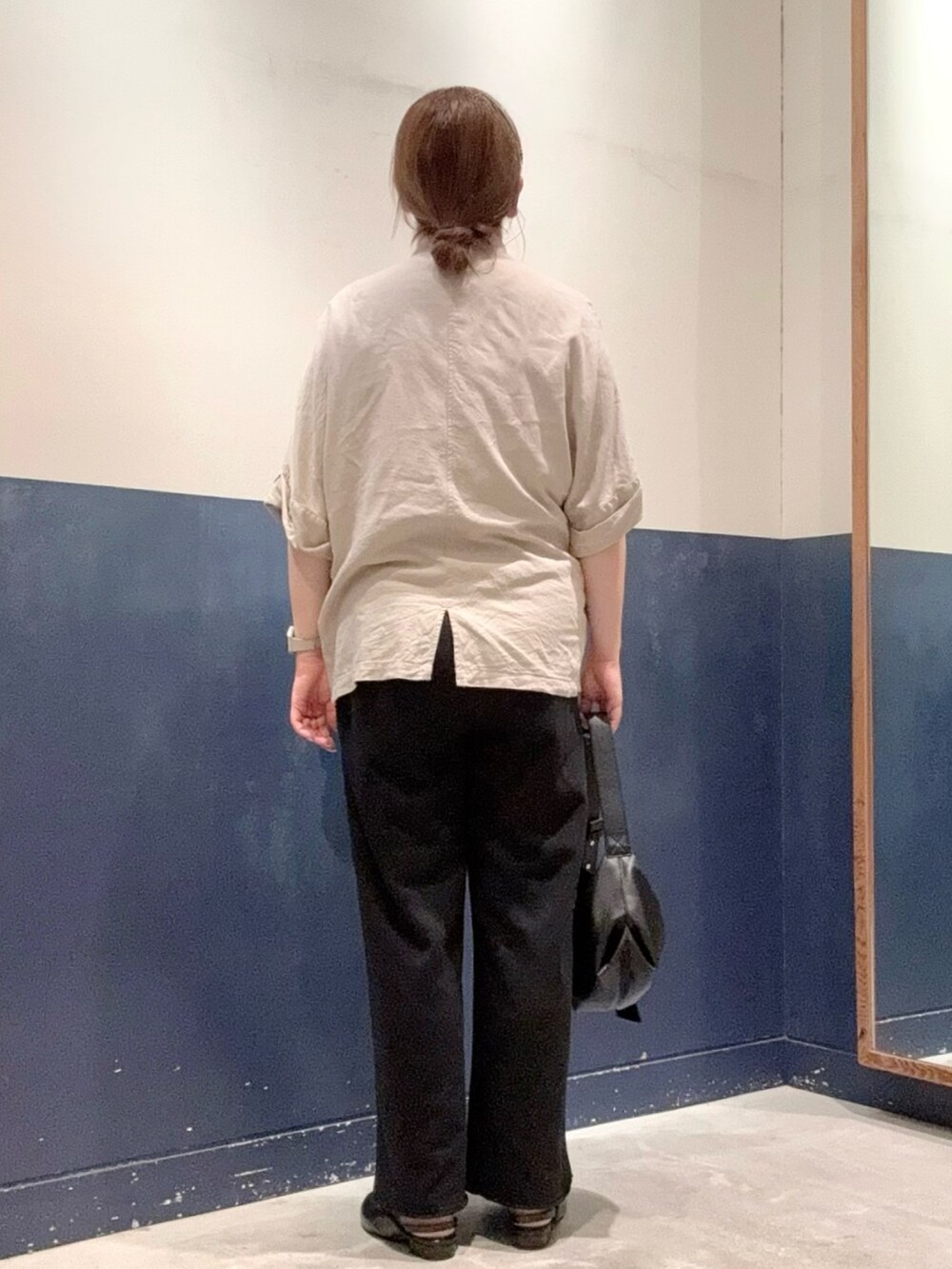 ブラック系のパンプス、ブラック系のショルダーバッグ、ブラック系のスウェットパンツを着用したレディースの夏コーディネートの3枚目の写真
