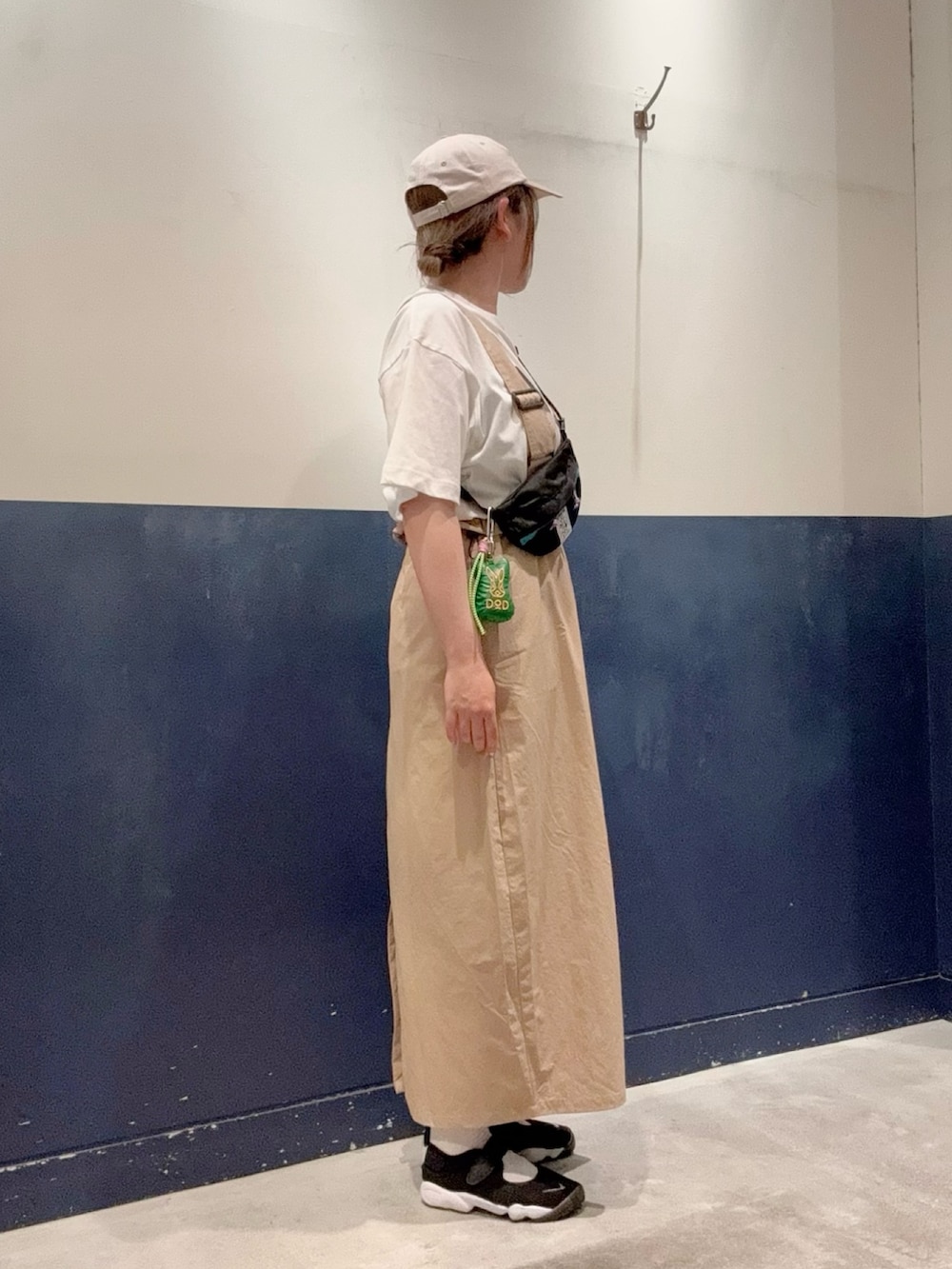 ホワイト系のTシャツ/カットソー、ブラック系のトートバッグ、ベージュ系のスカートを着用したレディースの春コーディネートの2枚目の写真