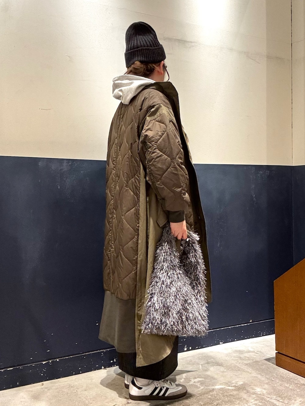 ホワイト系のTシャツ/カットソー、グリーン系のモッズコート、グレー系のトートバッグを着用したレディースの秋コーディネートの2枚目の写真