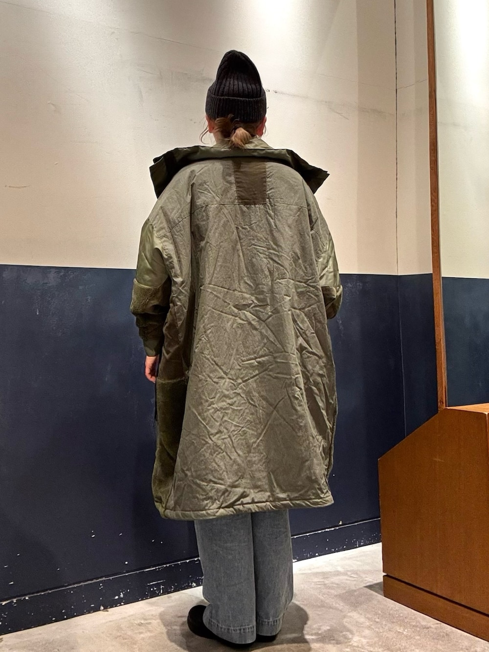 ブルー系のデニムパンツ、グリーン系のモッズコート、グレー系のニット/セーターを着用したレディースの冬コーディネートの3枚目の写真